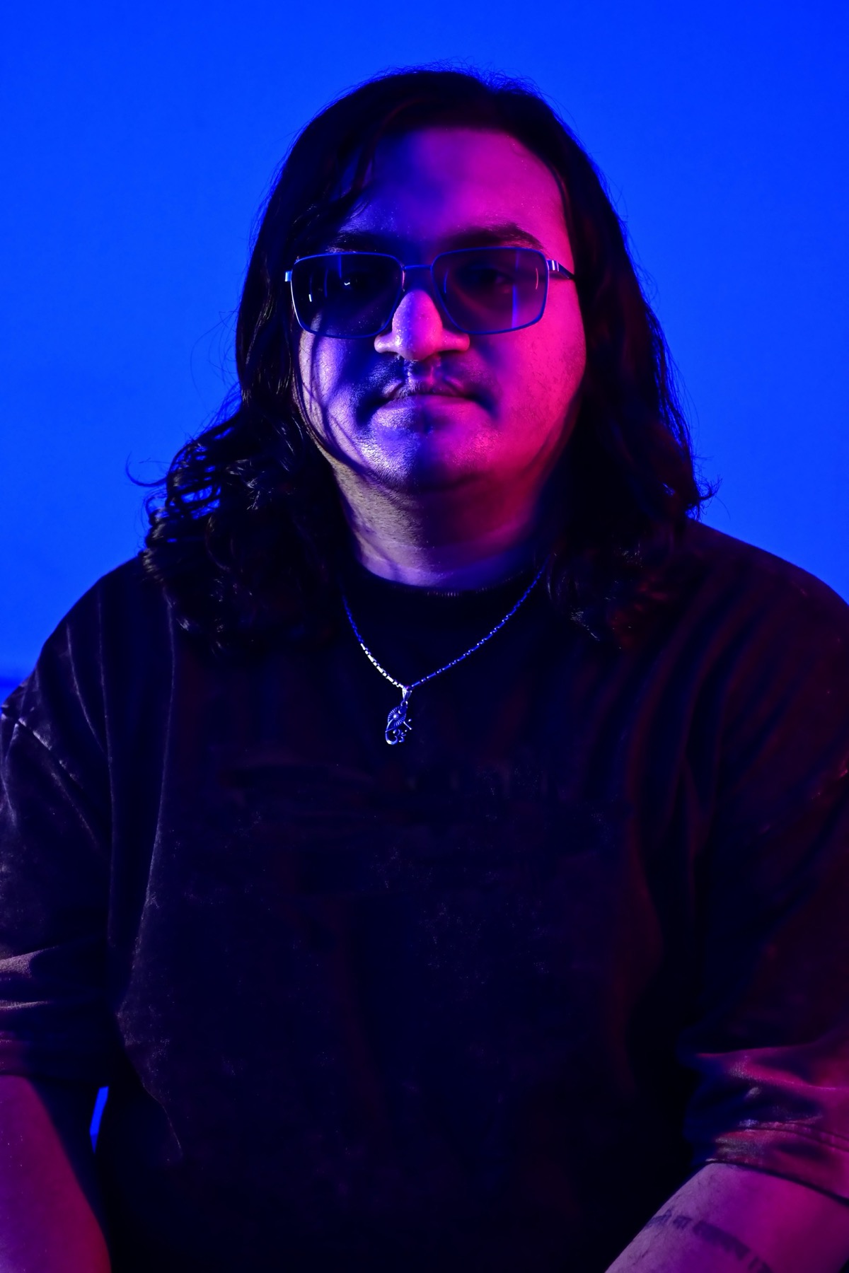 Sidallica facing camera in dual-tone blue and magenta light