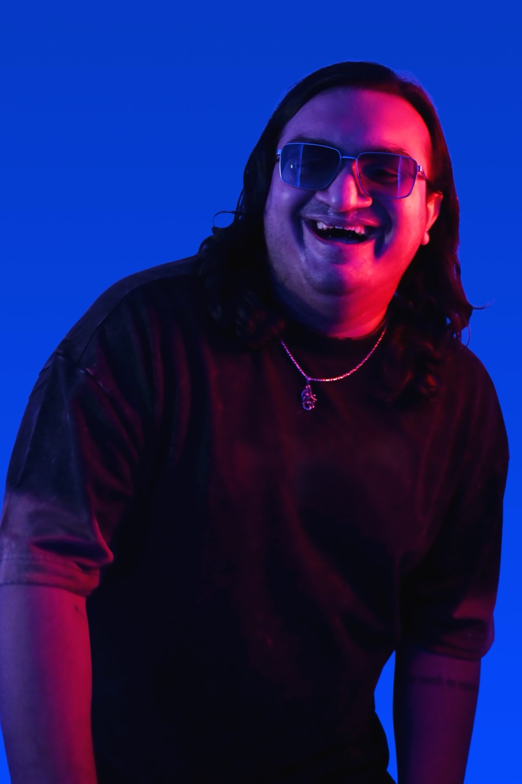 Sidallica laughing portrait in dual-tone light